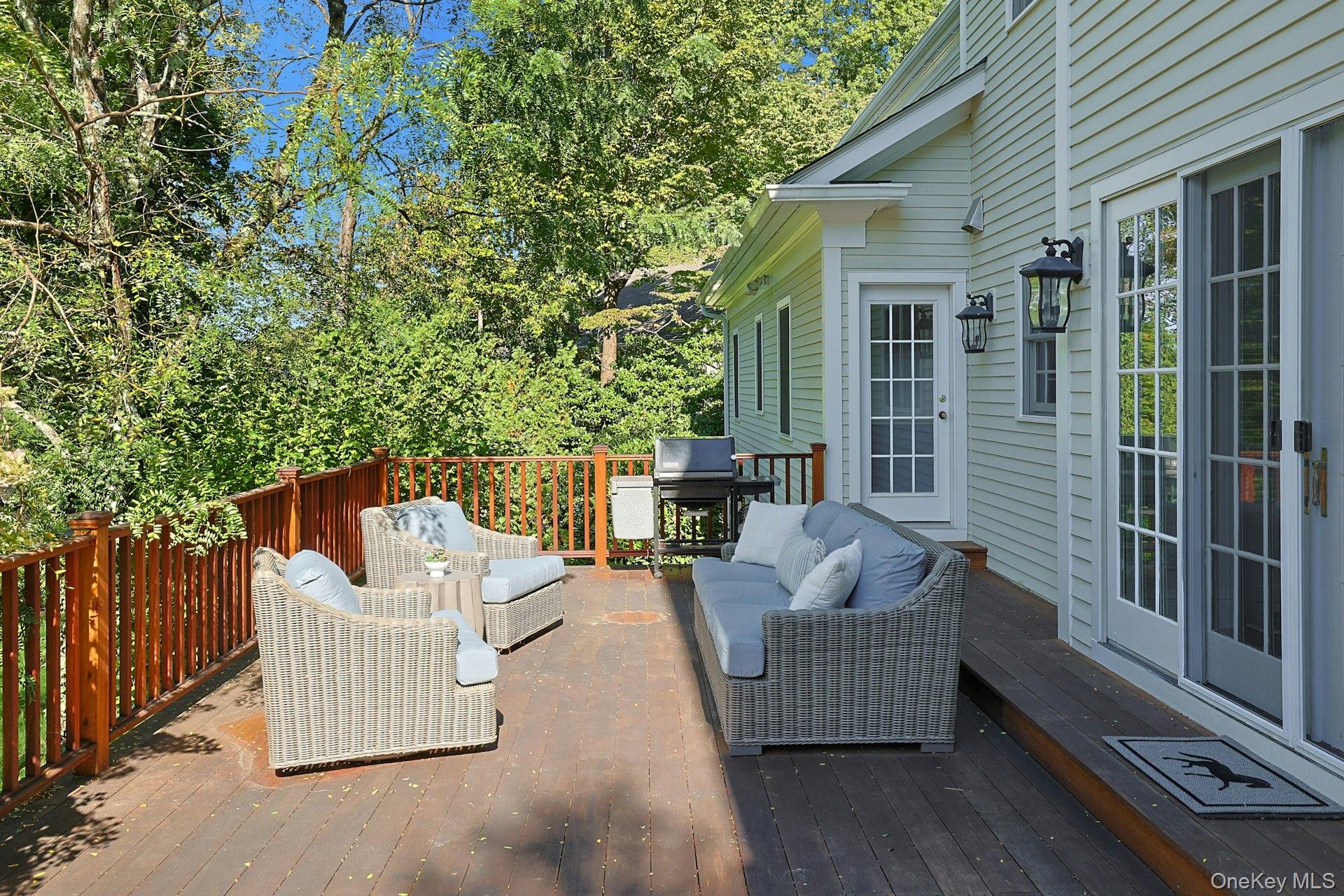 24 Fairview Road Scarsdale, NY 10583 - Photo 39 of 48 Spacious mahogany deck designed for outdoor dining and relaxed lounging—ideal for entertaining and everyday enjoyment.