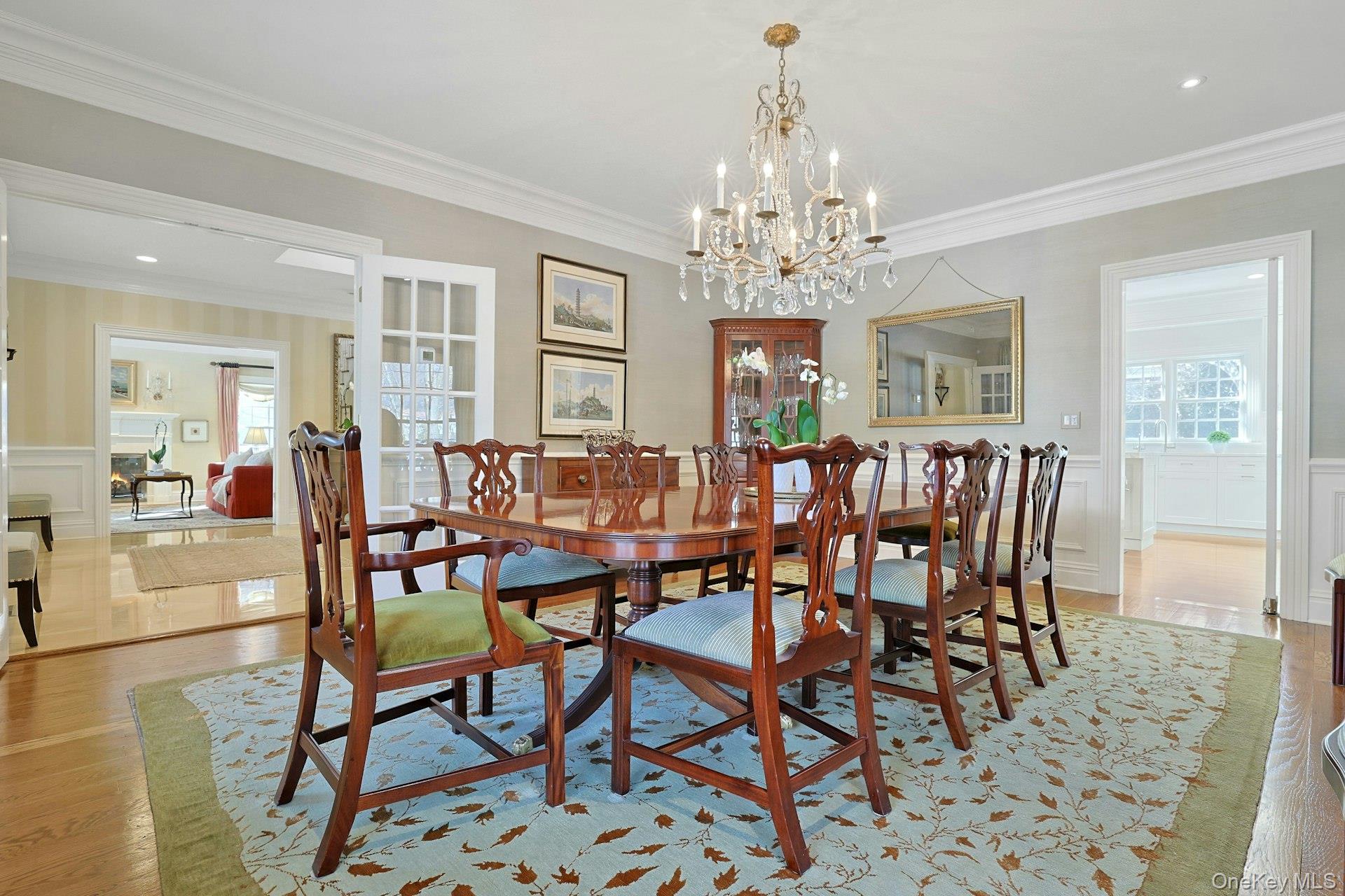 24 Fairview Road Scarsdale, NY 10583 - Photo 8 of 48 Another view of the dining room showcasing the room’s generous scale, natural light, and seamless flow to the kitchen and foyer.