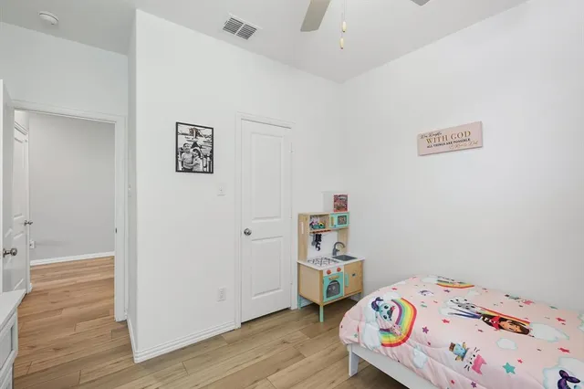 a bedroom with a bed and wooden floor