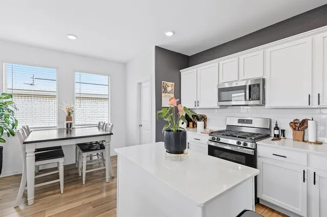 a kitchen with a white cabinets and appliances