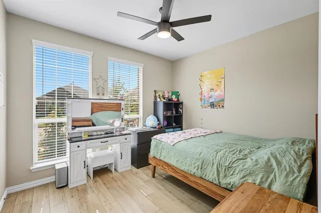 a bedroom with a bed dresser and a window