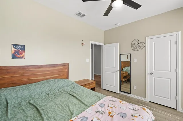 a bedroom with a bed and a dresser