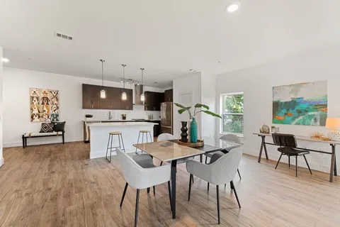 a view of a dining room with furniture and wooden floor