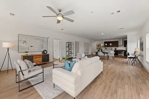 a living room with furniture and wooden floor