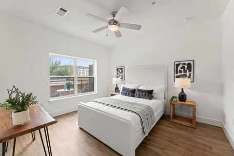 a room with a bed and a table in it