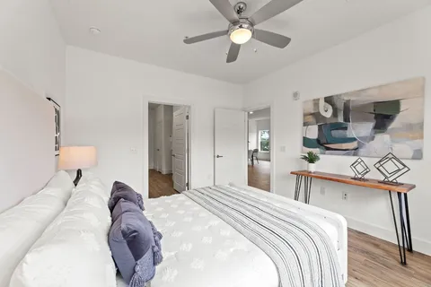 a bedroom with a bed and a chandelier