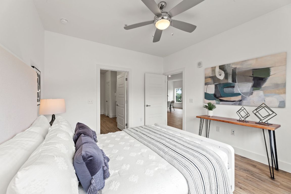 6444 Burnet Road, Unit 204 Austin, TX 78757 - Photo 19 of 36 a bedroom with a bed and a chandelier