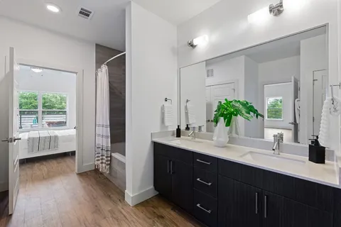 a bathroom with a double vanity sink and a mirror