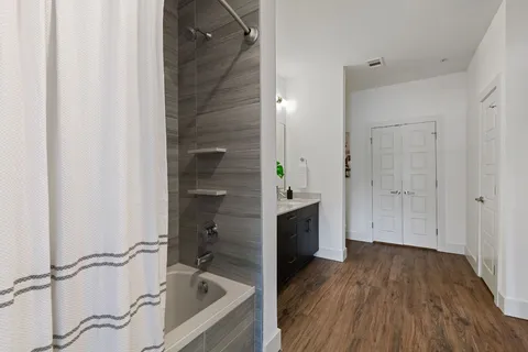 a spacious bathroom with a double vanity sink and mirror