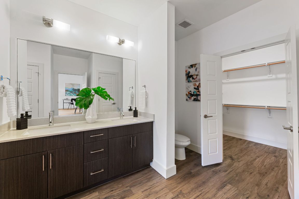 6444 Burnet Road, Unit 204 Austin, TX 78757 - Photo 22 of 36 a spacious bathroom with a double vanity sink and mirror
