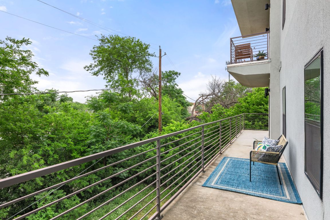 6444 Burnet Road, Unit 204 Austin, TX 78757 - Photo 26 of 36 a balcony with wooden floor table and chairs