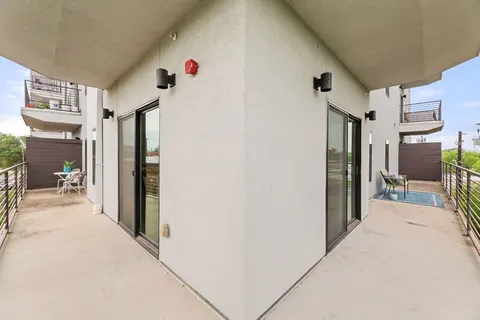 a balcony view with a glass door
