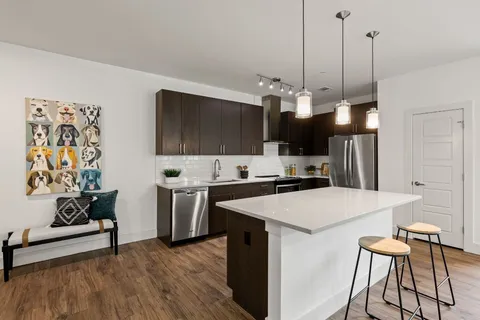 a kitchen with stainless steel appliances a stove a sink and a refrigerator