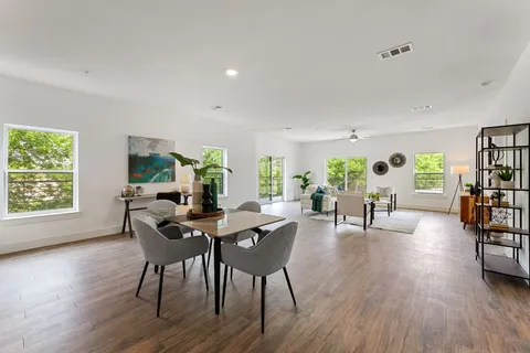 a view of a livingroom with furniture window and wooden floor