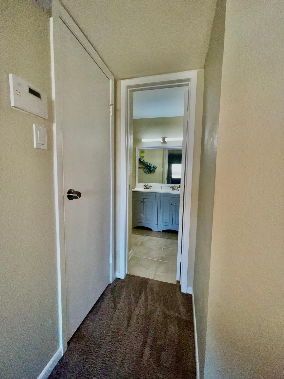 3055 Walnut Bend Lane, Unit 36 Houston, TX 77042 - Photo 12 of 16 a view of a hallway and bathroom with mirror