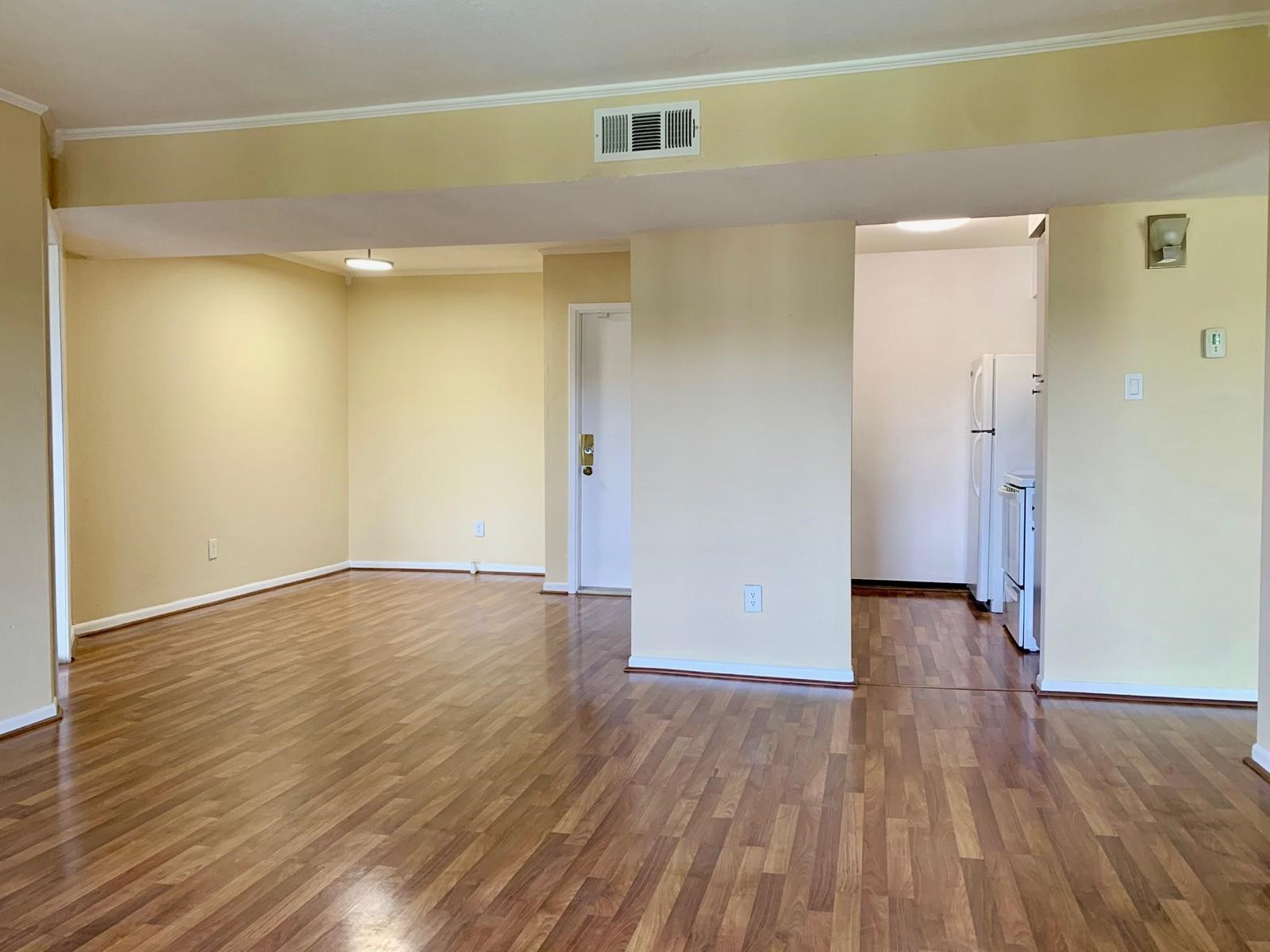 3055 Walnut Bend Lane, Unit 36 Houston, TX 77042 - Photo 4 of 16 a view of an empty room with wooden floor and a window
