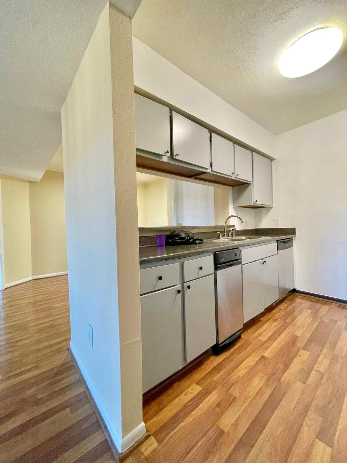 3055 Walnut Bend Lane, Unit 36 Houston, TX 77042 - Photo 6 of 16 a kitchen with stainless steel appliances granite countertop a sink and cabinets with wooden floor