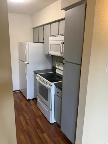 a kitchen with a refrigerator and a stove