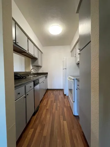 a kitchen with stainless steel appliances a refrigerator and a stove top oven