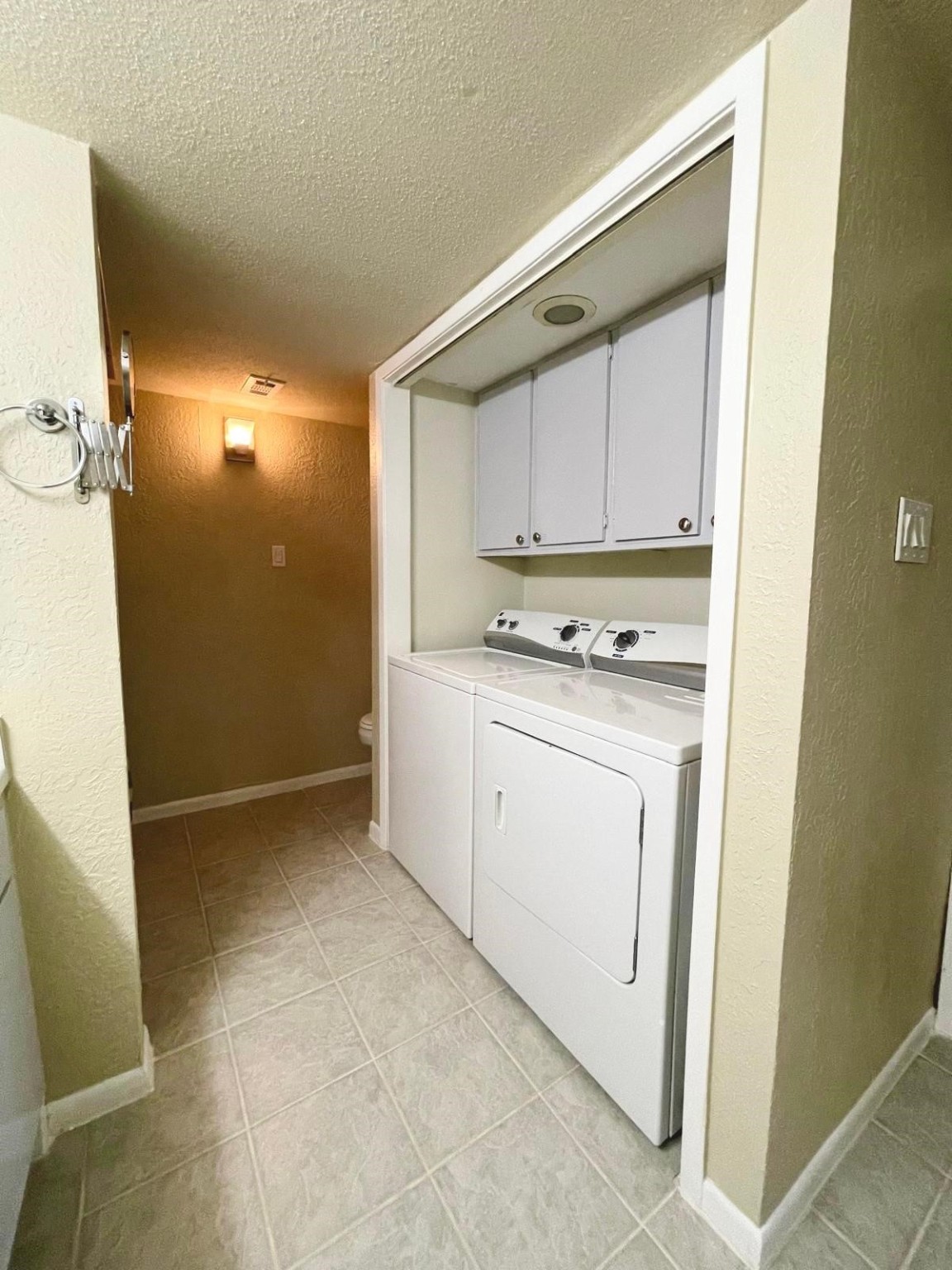 3055 Walnut Bend Lane, Unit 36 Houston, TX 77042 - Photo 10 of 16 a utility room with cabinets washer and dryer