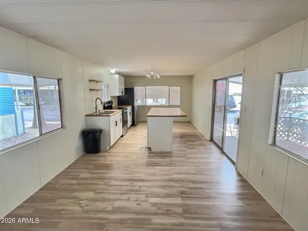 a view of a kitchen with wooden floor and electronic appliances