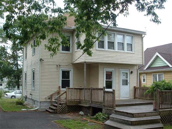 61 Mooreland Street Springfield, MA 01104 - Photo 2 of 8 a view of a house with a yard and plants