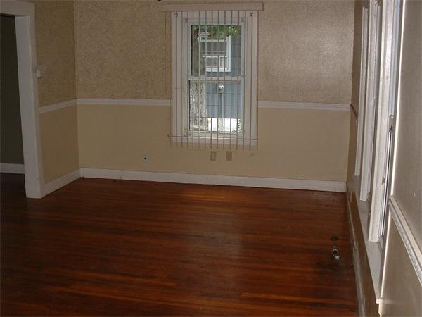 61 Mooreland Street Springfield, MA 01104 - Photo 4 of 8 a view of empty room with wooden floor and fan