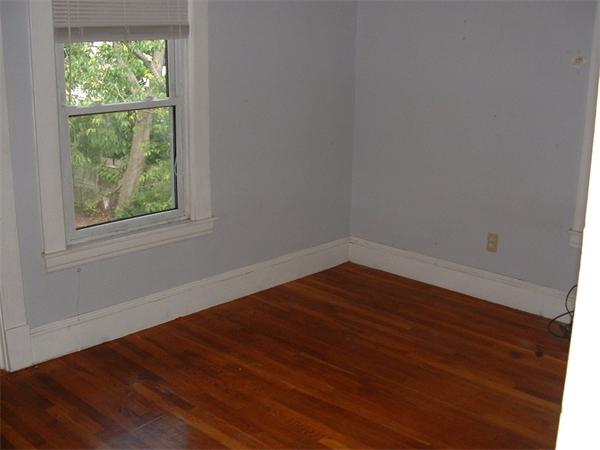 61 Mooreland Street Springfield, MA 01104 - Photo 7 of 8 an empty room with wooden floor and windows