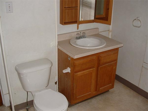 61 Mooreland Street Springfield, MA 01104 - Photo 8 of 8 a bathroom with a toilet a sink and mirror