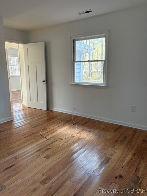 171 Lillys Neck Road Moon, VA 23119 - Photo 24 of 38 Empty room featuring visible vents, plenty of natural light, baseboards, and light wood-type flooring