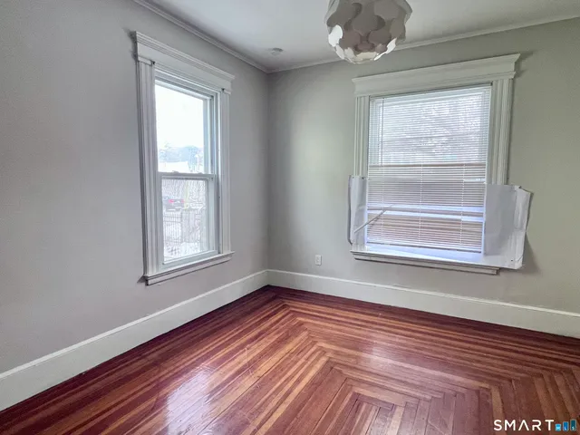 a view of walk in closet with wooden floor