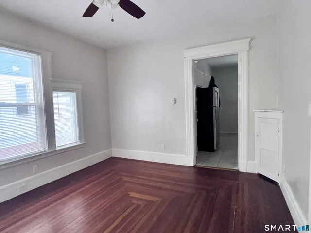 wooden floor in an empty room with a window