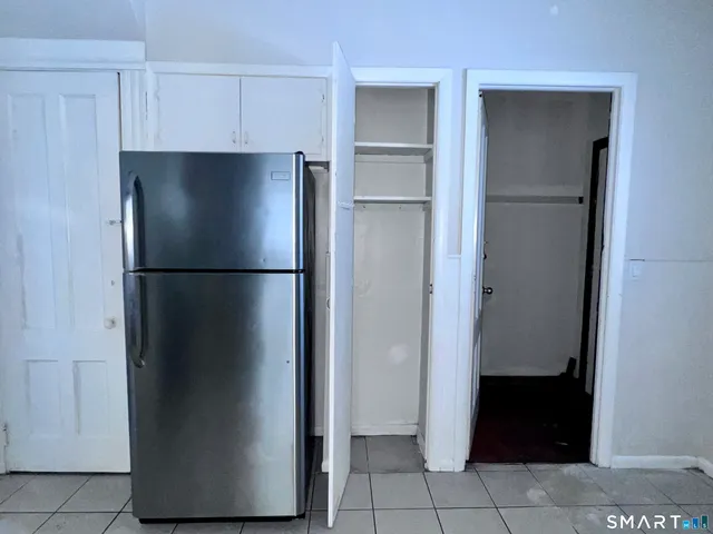 a refrigerator freezer sitting in a kitchen