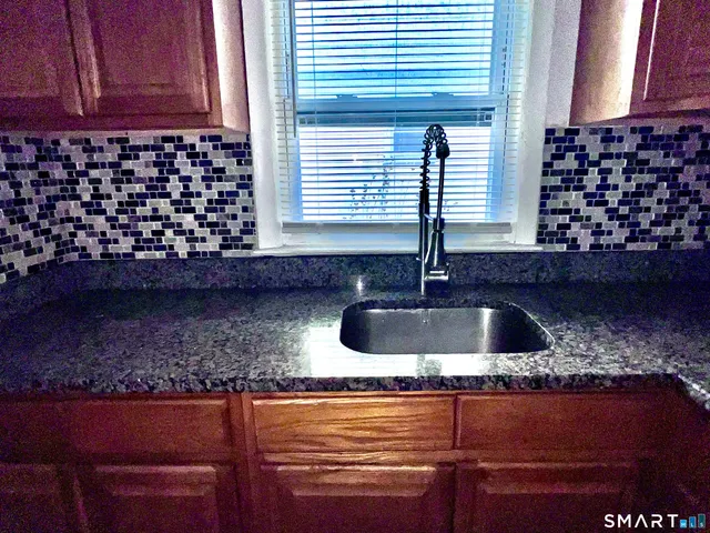 a kitchen with a refrigerator and a stove top oven
