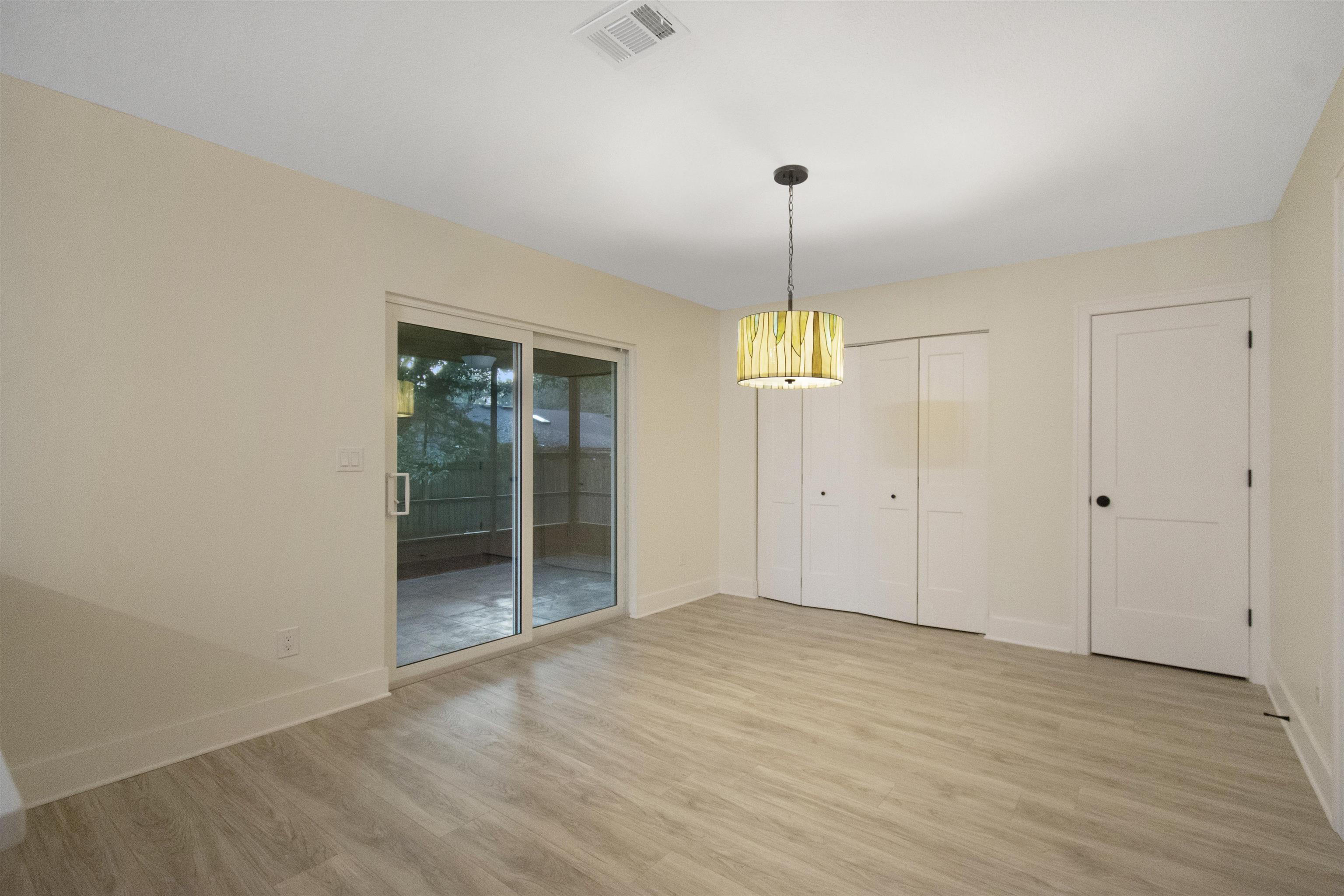 209 Jasmine Road St. Augustine, FL 32086 - Photo 12 of 25 wooden floor in an empty room with a window