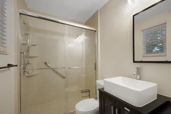 a bathroom with a sink toilet and shower