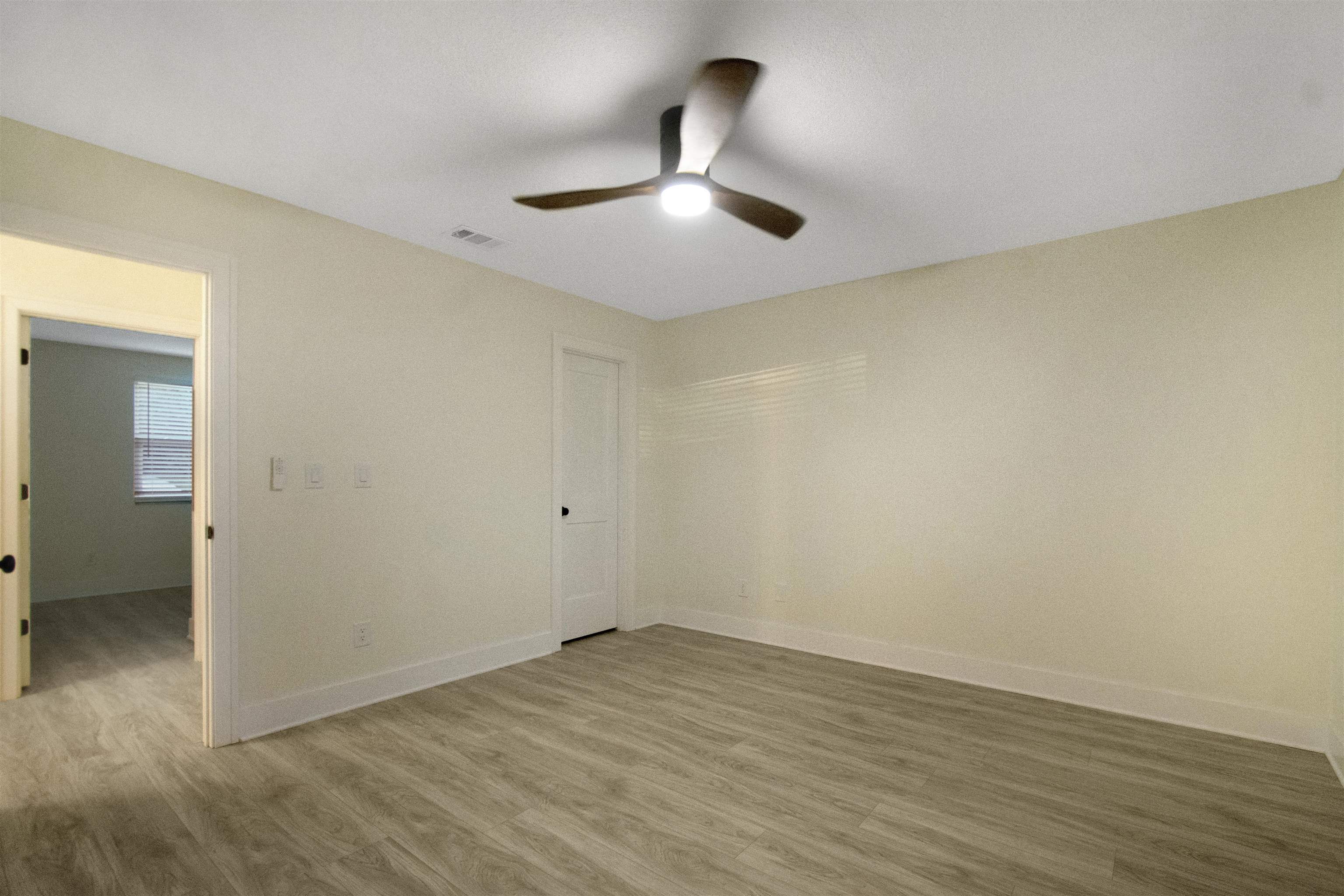 209 Jasmine Road St. Augustine, FL 32086 - Photo 15 of 25 an empty room with wooden floor and fan