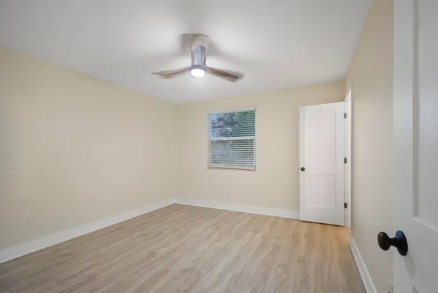 wooden floor in an empty room with a window