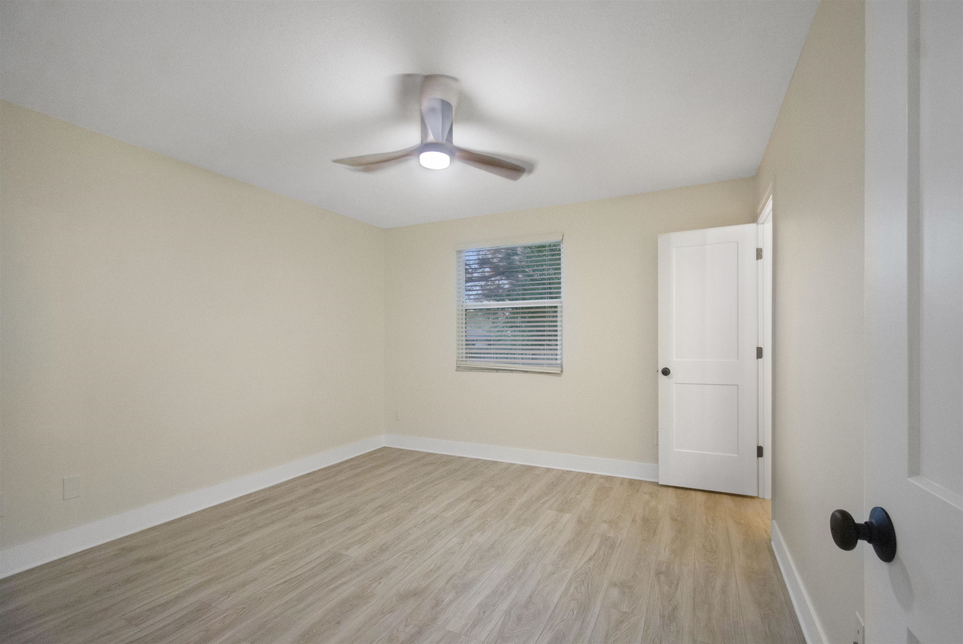 209 Jasmine Road St. Augustine, FL 32086 - Photo 16 of 25 wooden floor in an empty room with a window