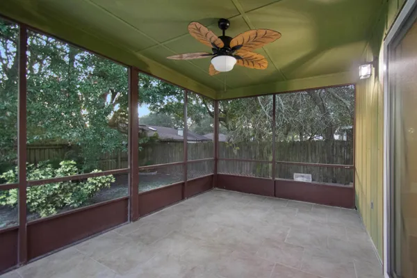 a view of a livingroom with a ceiling fan and window