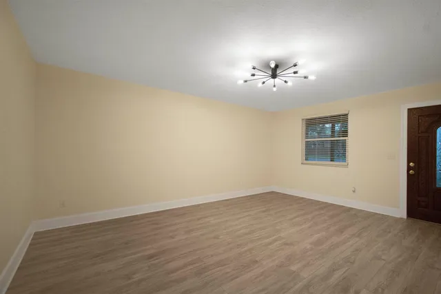 a view of a room with an empty space and a ceiling fan