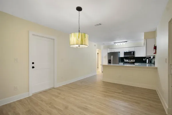 a view of a kitchen with stainless steel appliances granite countertop a refrigerator a stove and a sink