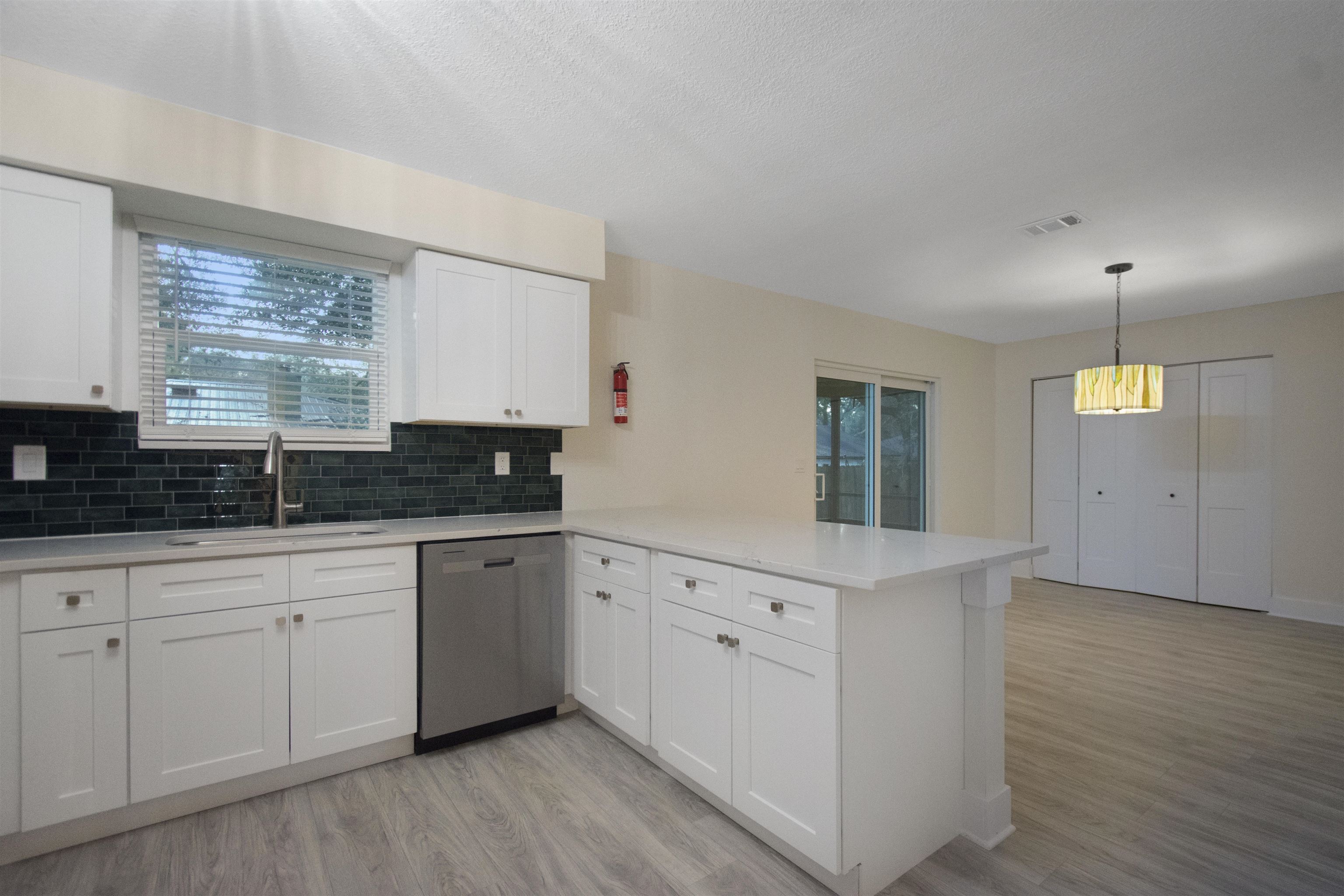 209 Jasmine Road St. Augustine, FL 32086 - Photo 9 of 25 a kitchen with white cabinets and sink