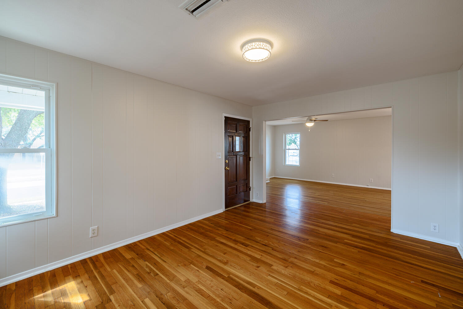 1400 Ruth Avenue Austin, TX 78757 - Photo 5 of 29 Polished hardwood floors and clean paneled walls define this welcoming living space.
