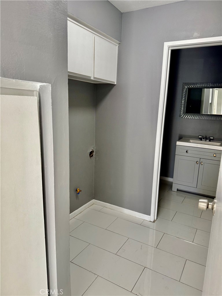 470 West Jackson Street Rialto, CA 92376 - Photo 11 of 28 a view of a kitchen with white cabinets and a refrigerator