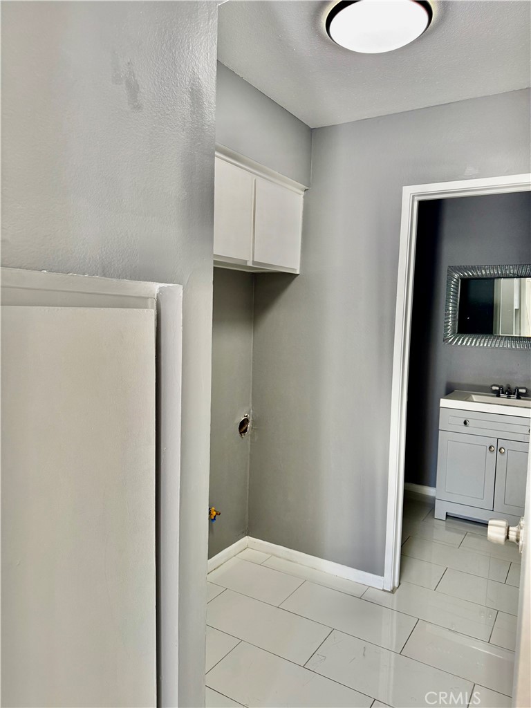 470 West Jackson Street Rialto, CA 92376 - Photo 12 of 28 a bathroom with a granite countertop sink and a mirror