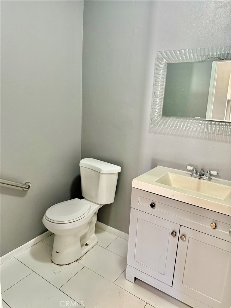 470 West Jackson Street Rialto, CA 92376 - Photo 13 of 28 a bathroom with a toilet sink and mirror