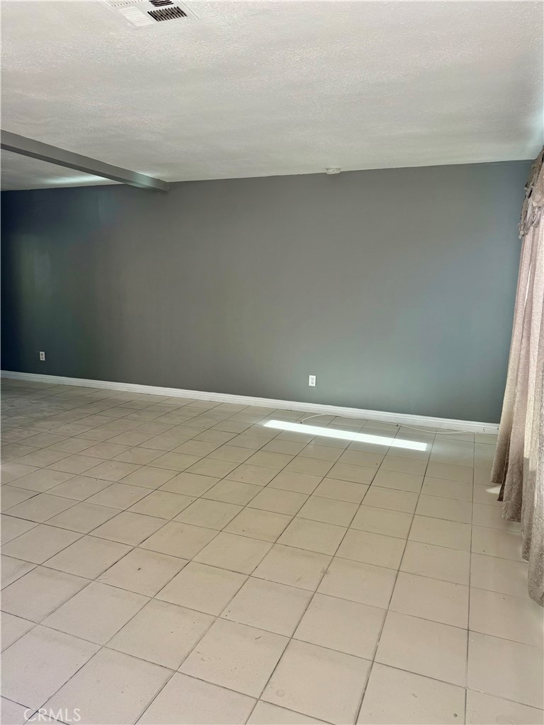 470 West Jackson Street Rialto, CA 92376 - Photo 6 of 28 a view of a refrigerator in an empty room
