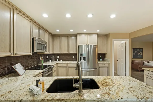 a kitchen with a stove a sink and a microwave