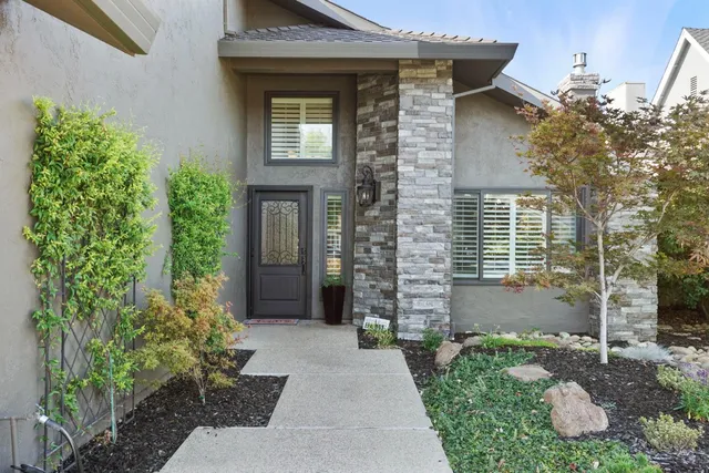 a front view of a house with garden